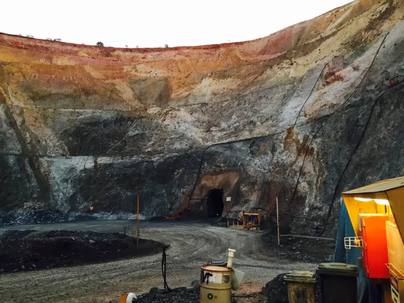 A portal at the bottom of an open pit, where the decline goes underground